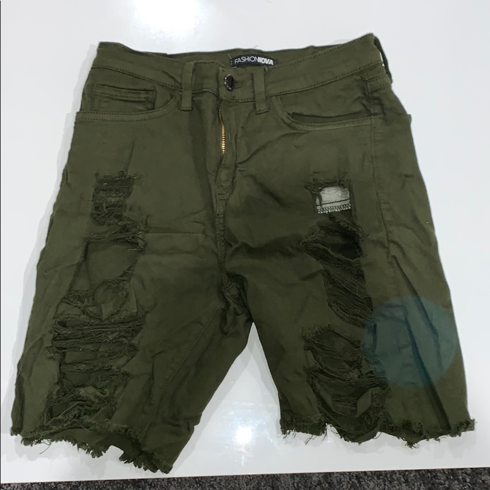 Green ripped Bermuda shorts